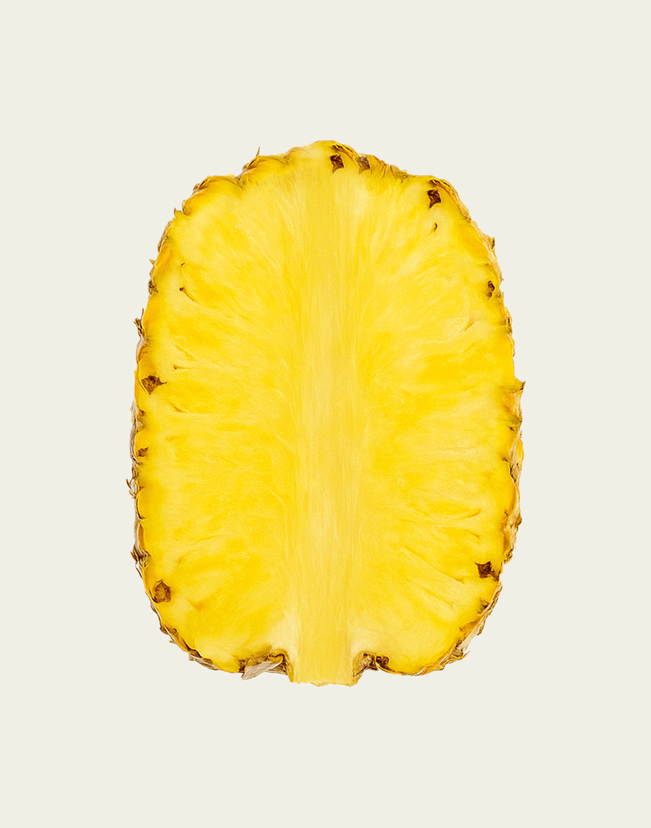 Half-cut pineapple on a light beige background