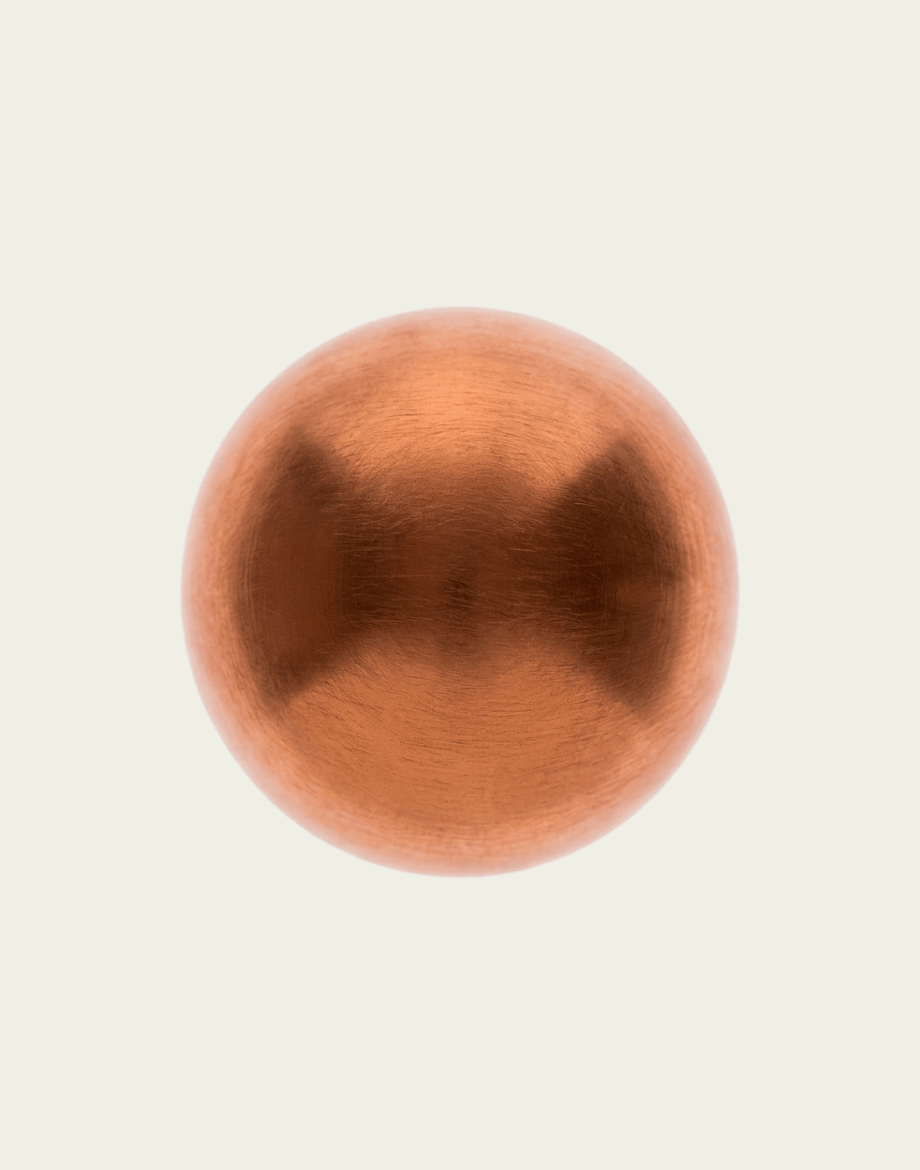 Copper sphere on a beige background
