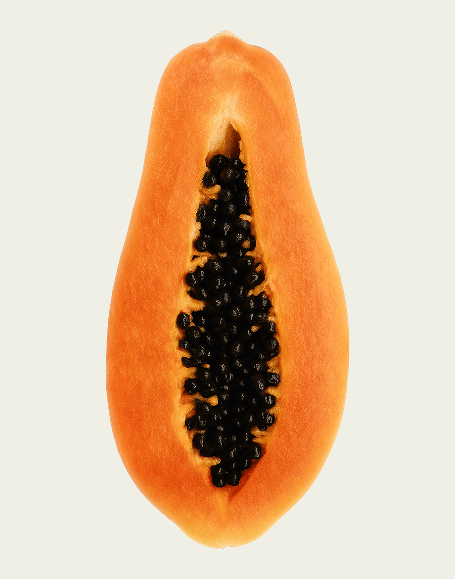 Half-cut papaya with black seeds on a light beige background