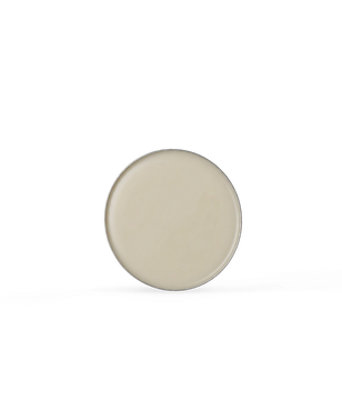 Round aluminum tin with beige lip balm filling on a white background