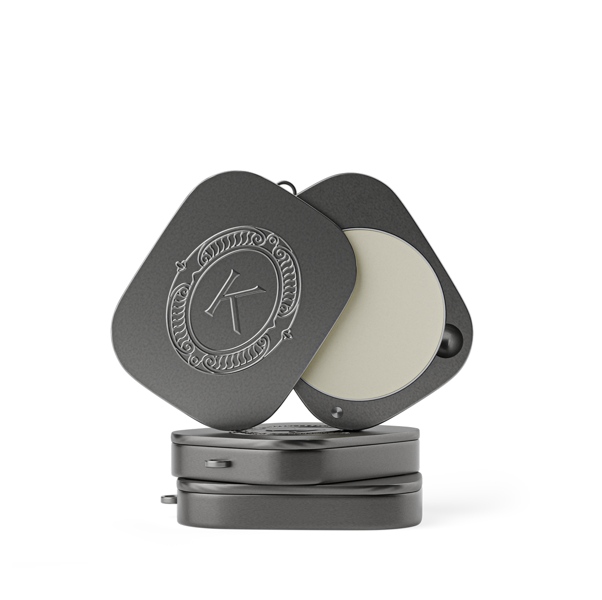 Grey lip balm compact with a lid featuring an embossed K logo on a white background