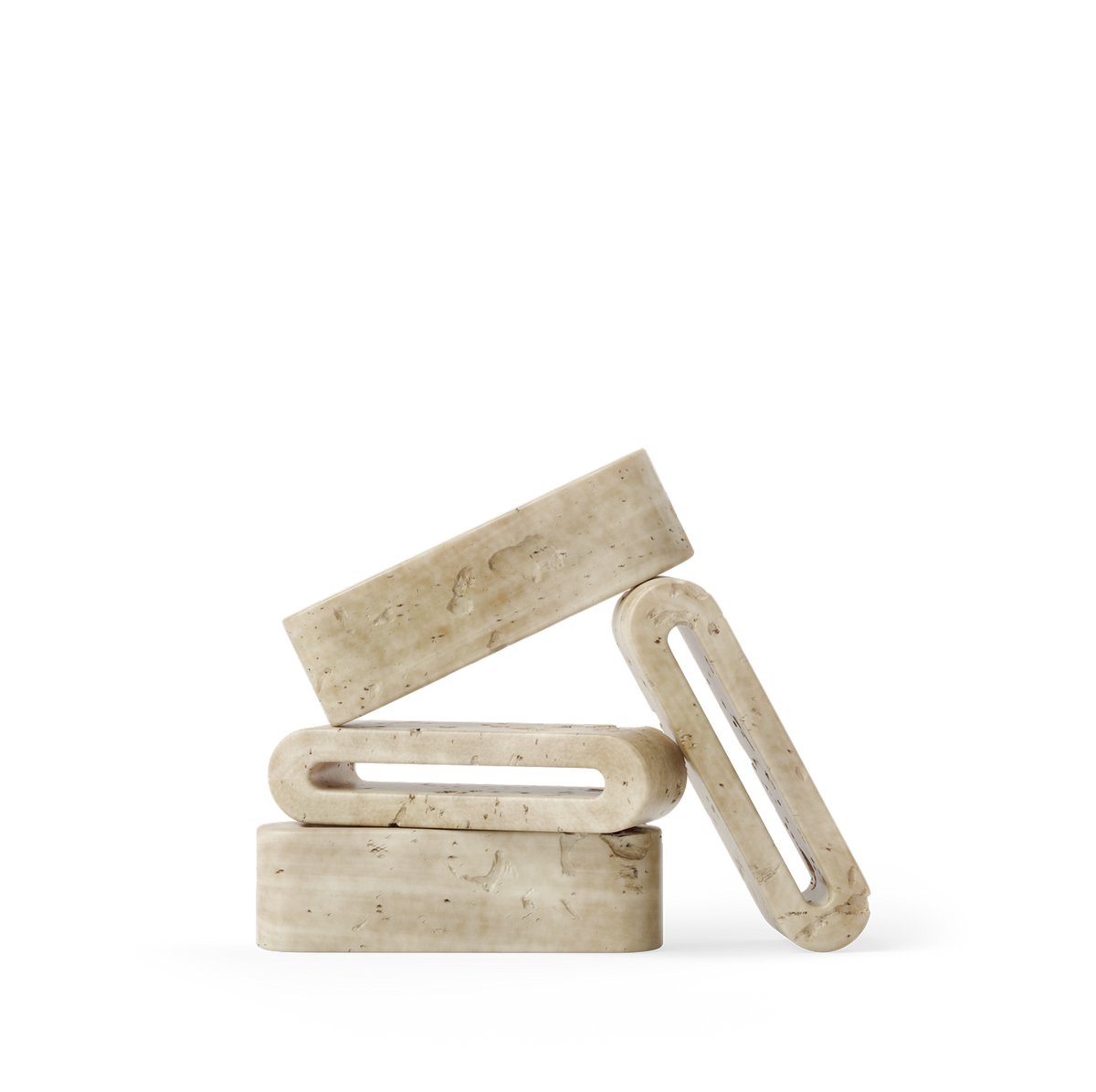 Three beige travertine rectangular objects stacked on a white background