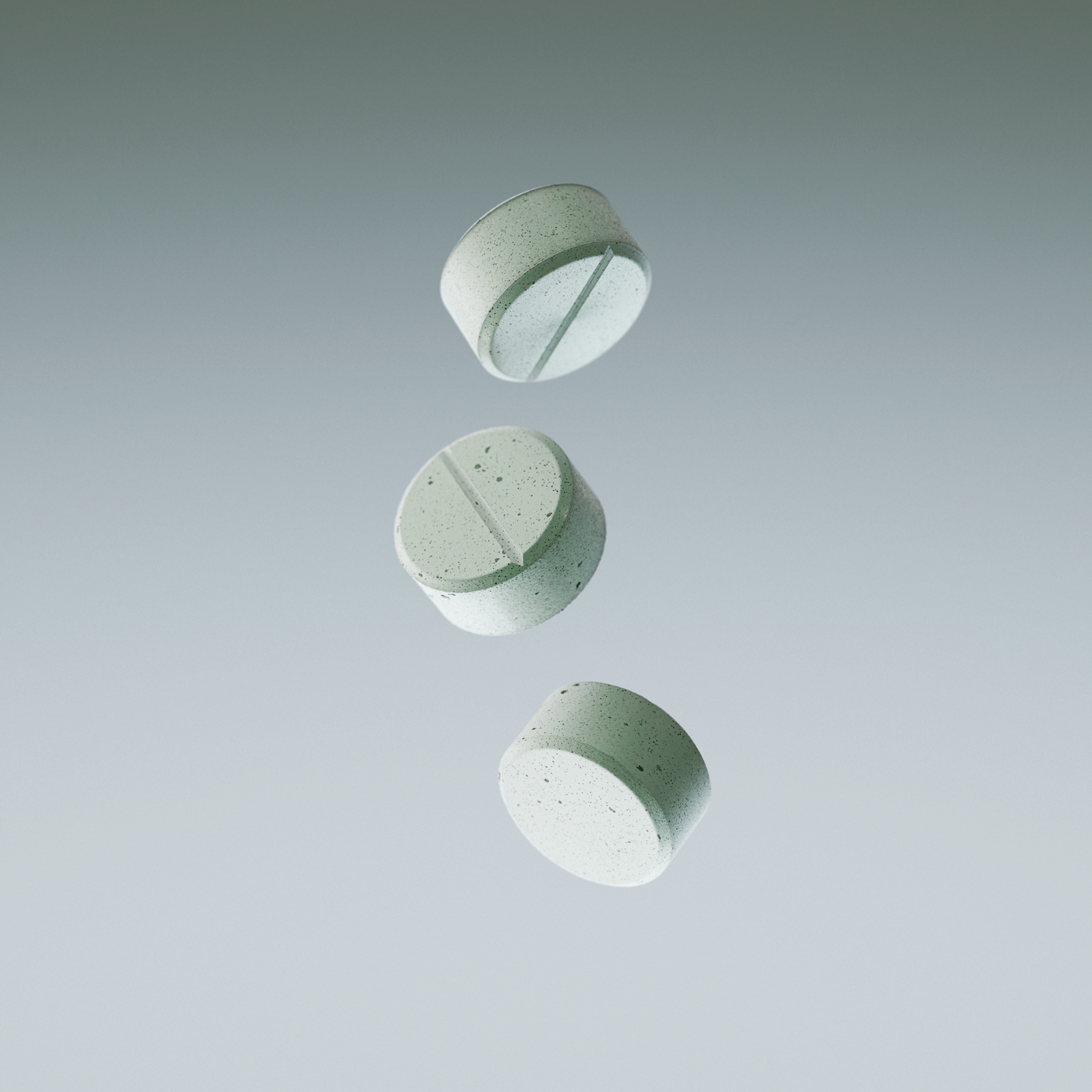Three green mints falling against a gray background