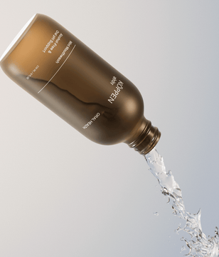 Brown amber frosted bottle with 'KOPPEN' text pouring clear liquid on a light gray background