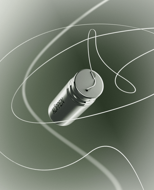 Silver cylindrical floss container with 'Koppen' branding on a green gradient background