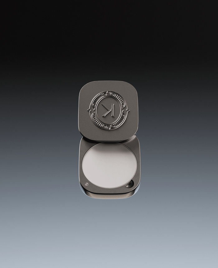 Grey lip balm compact with K brand logo on a gradient background