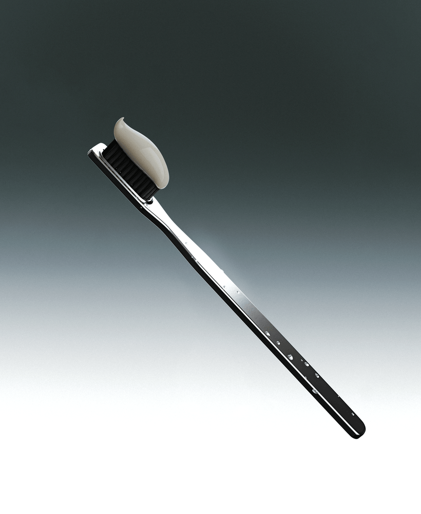 Metallic toothbrush with a black bristle head and white toothpaste on a gradient gray background