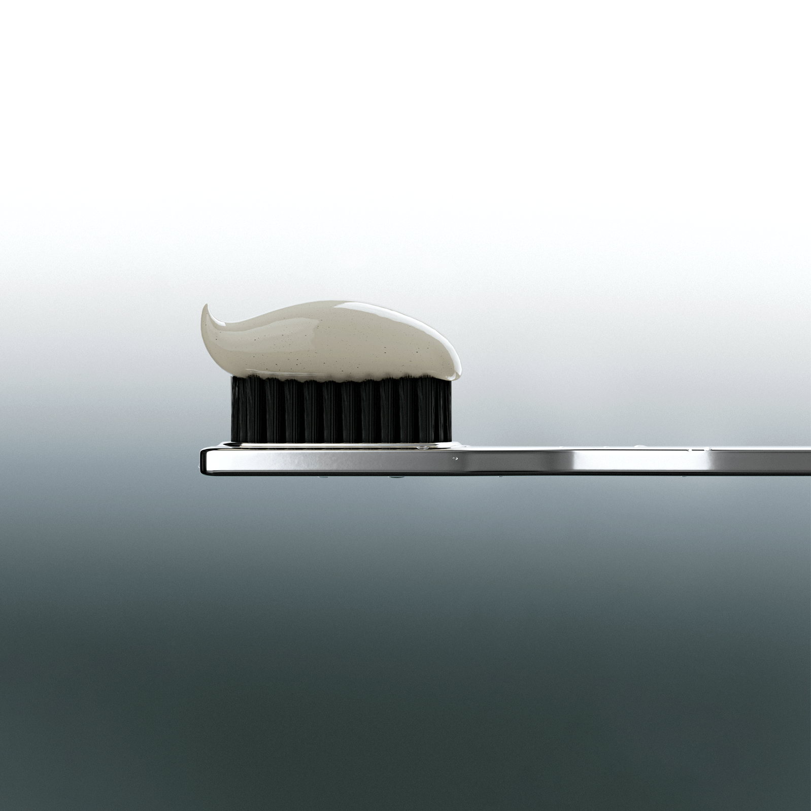 Metallic toothbrush a small amount of toothpaste on a gray background